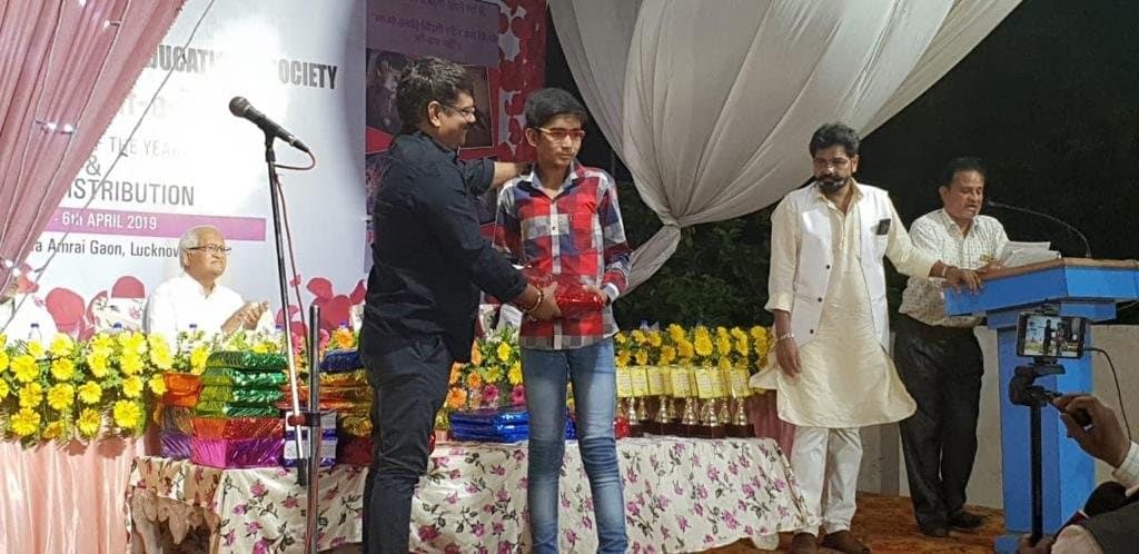 A student receives a prize on stage